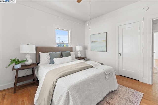 bedroom with wood-type flooring and ceiling fan