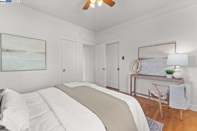 bedroom featuring hardwood / wood-style floors, crown molding, and ceiling fan