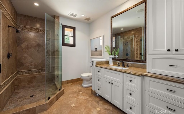 bathroom featuring vanity, toilet, and walk in shower