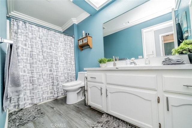 bathroom featuring toilet, wood-type flooring, ornamental molding, vanity, and a shower with shower curtain