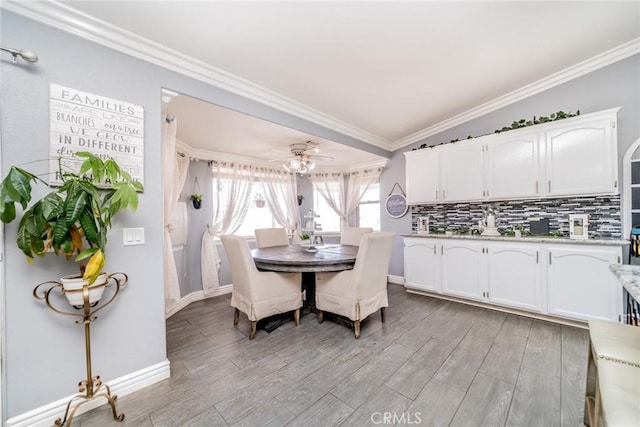 kitchen featuring ornamental molding, light hardwood / wood-style floors, and white cabinets