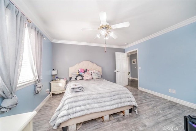 bedroom featuring ceiling fan, ornamental molding, and hardwood / wood-style floors