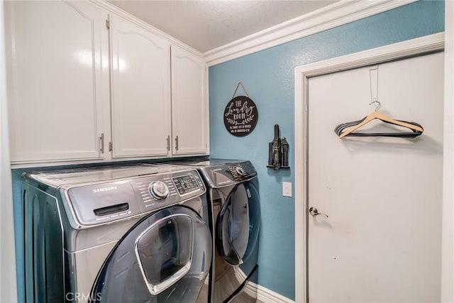 washroom featuring crown molding, independent washer and dryer, and cabinets