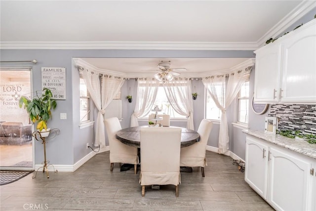 dining room with ornamental molding, wood-type flooring, and ceiling fan