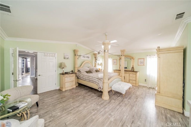 bedroom featuring crown molding, multiple windows, and light wood-type flooring