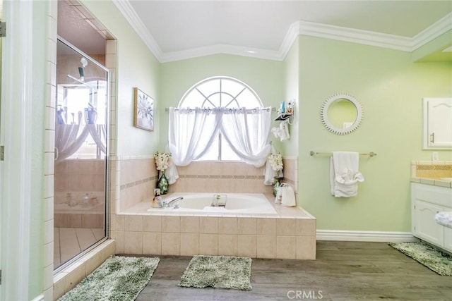 bathroom featuring ornamental molding, separate shower and tub, hardwood / wood-style floors, and vanity