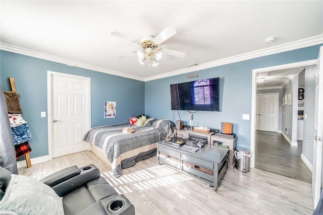 bedroom with ceiling fan, ornamental molding, and hardwood / wood-style floors