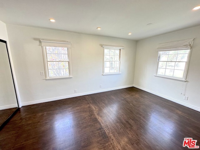 spare room with dark hardwood / wood-style flooring