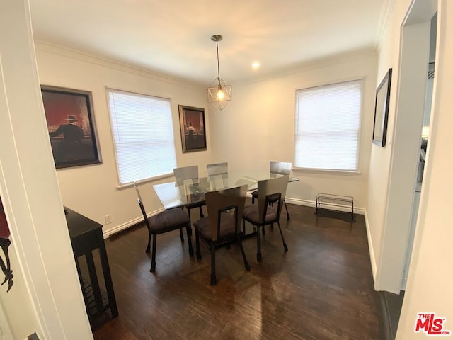 dining room with dark hardwood / wood-style flooring, ornamental molding, and a healthy amount of sunlight