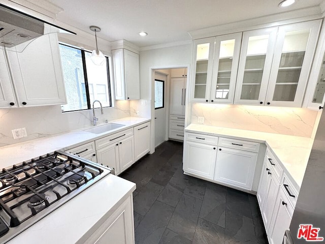 kitchen featuring sink, pendant lighting, and white cabinets