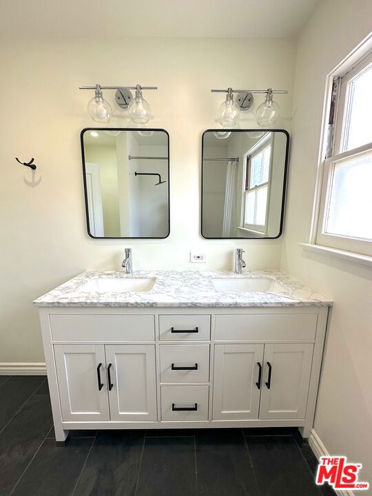 bathroom with tile patterned floors and vanity