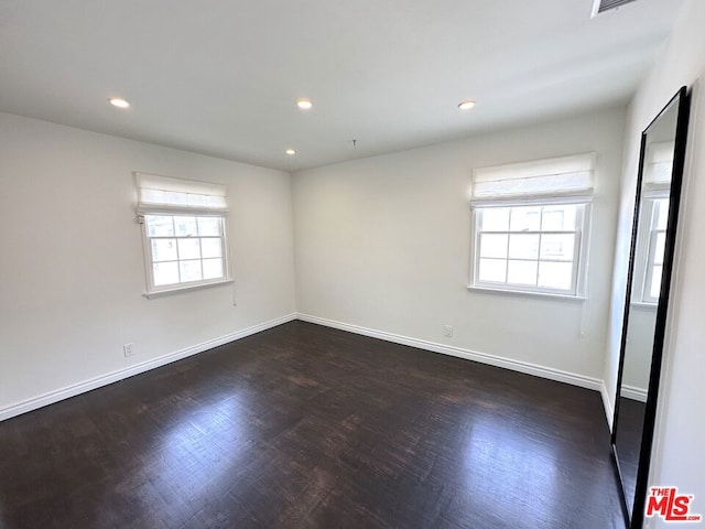 unfurnished room featuring dark wood-type flooring