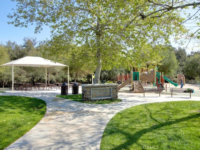 view of community featuring a playground and a yard