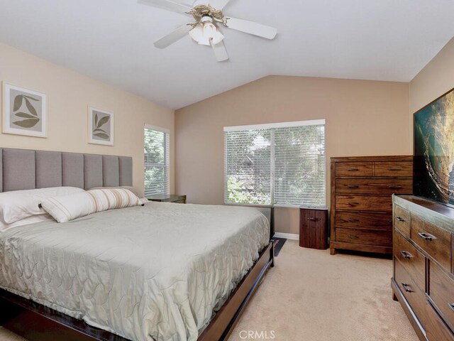 bedroom with lofted ceiling, light carpet, and ceiling fan