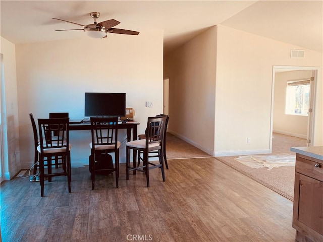 dining space featuring ceiling fan, wood finished floors, and baseboards