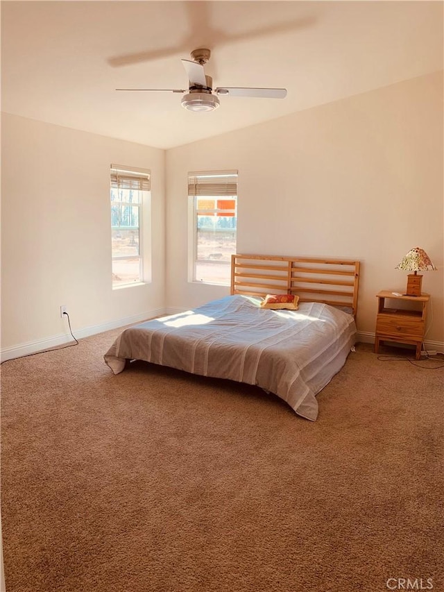 carpeted bedroom featuring vaulted ceiling, baseboards, and ceiling fan