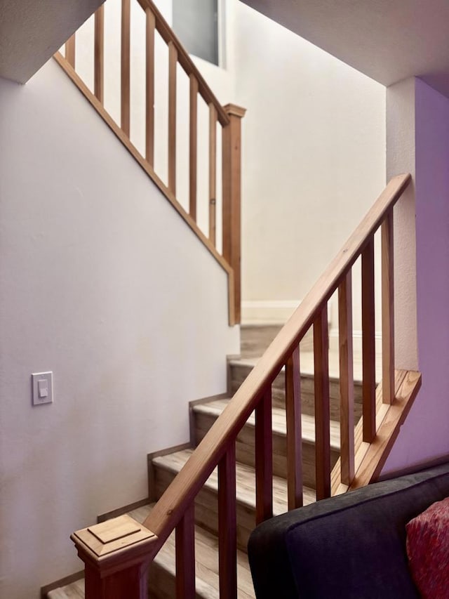 stairs featuring hardwood / wood-style flooring