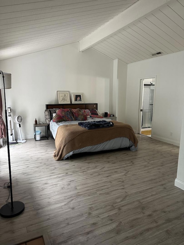 bedroom featuring wood-type flooring and lofted ceiling with beams