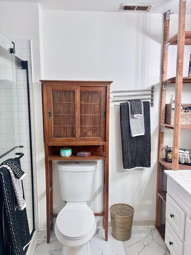 bathroom featuring vanity, toilet, and walk in shower