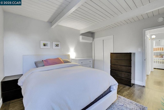 bedroom featuring wood ceiling, a wall unit AC, wood-type flooring, a closet, and beamed ceiling