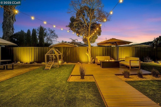 exterior space with a wooden deck and an outdoor living space with a fire pit