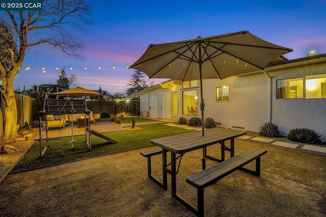 view of community with a wooden deck and a yard