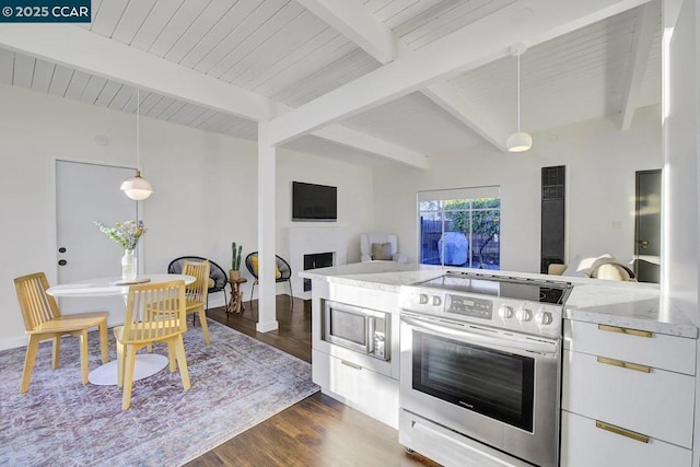 kitchen featuring dark wood-type flooring, stainless steel appliances, light stone countertops, white cabinets, and decorative light fixtures