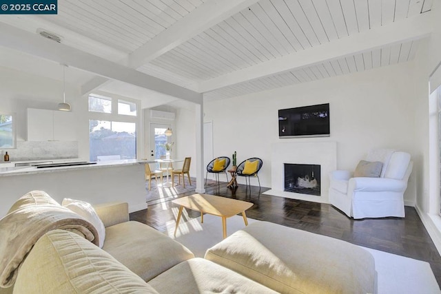 living room with beam ceiling and dark parquet flooring