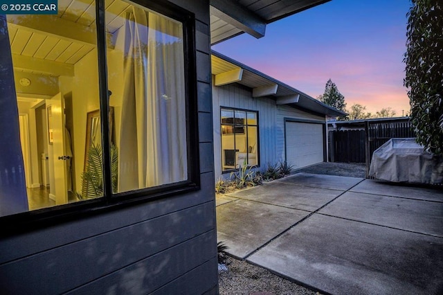 property exterior at dusk featuring a garage