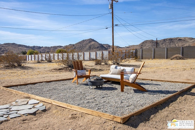 view of yard with a mountain view and a fire pit