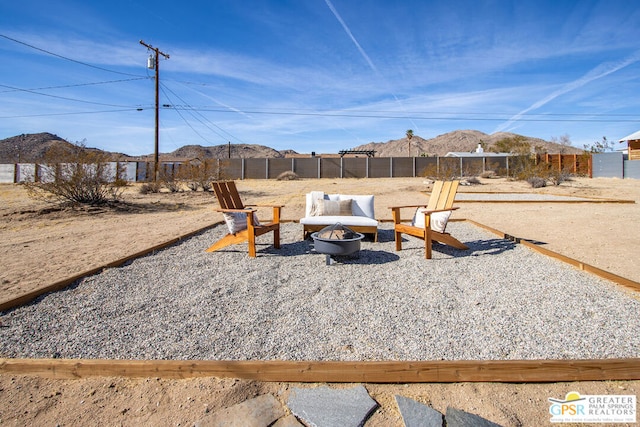 view of yard with a mountain view and an outdoor fire pit