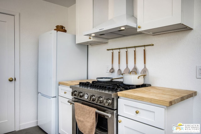 kitchen with wood counters, stainless steel range with gas stovetop, range hood, and white cabinets