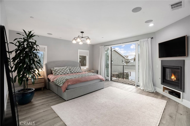 bedroom with light hardwood / wood-style floors and access to outside