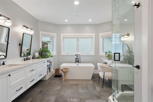 bathroom featuring shower with separate bathtub and vanity