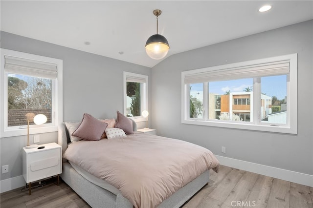 bedroom with lofted ceiling and hardwood / wood-style floors