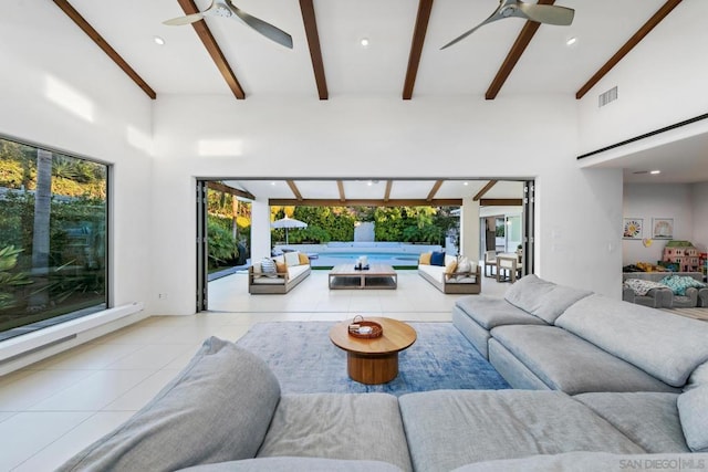 tiled living room featuring beam ceiling, high vaulted ceiling, and ceiling fan