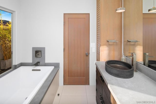 bathroom featuring tile patterned flooring, vanity, and a bathtub