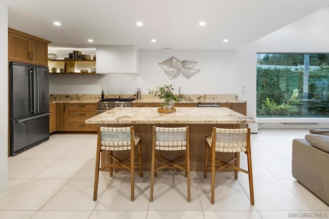 kitchen with a kitchen bar, a center island, custom range hood, and premium appliances