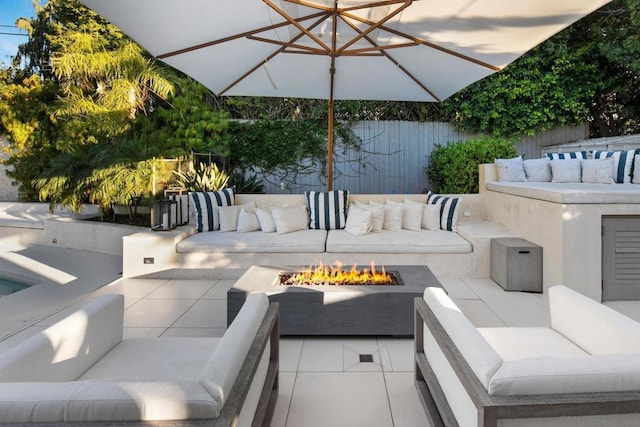 view of patio / terrace featuring an outdoor living space with a fire pit