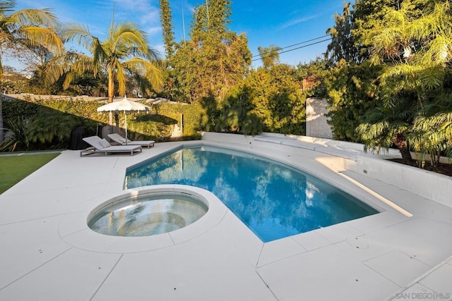 view of swimming pool with a patio and an in ground hot tub