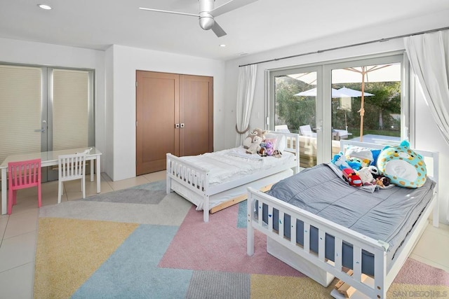 tiled bedroom featuring ceiling fan and a closet