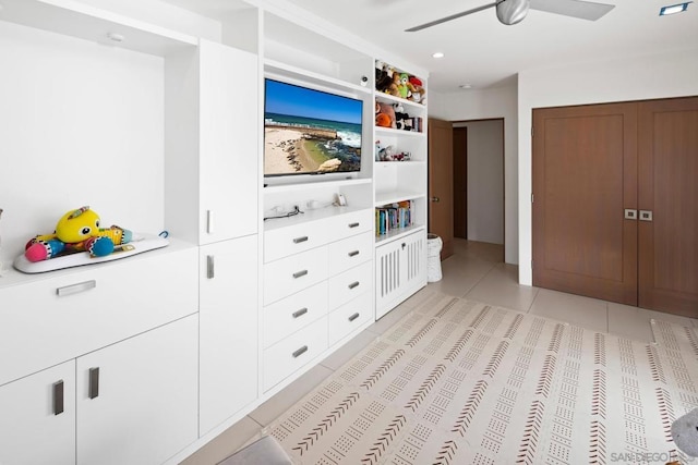 tiled bedroom featuring ceiling fan