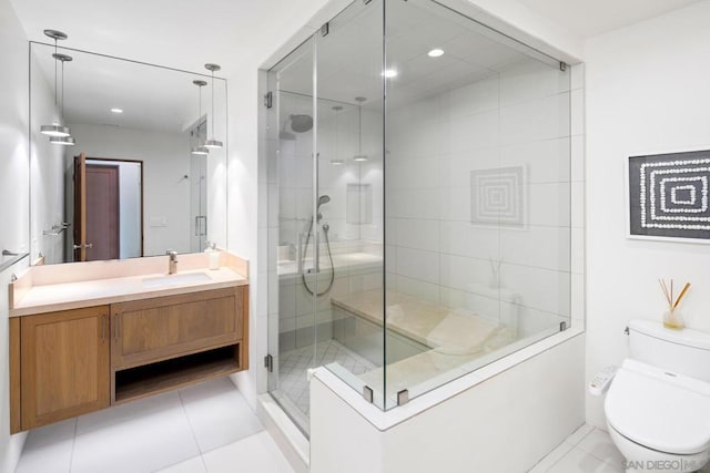 bathroom with an enclosed shower, vanity, tile patterned flooring, and toilet