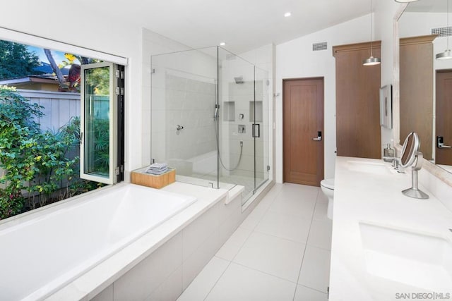 full bathroom with lofted ceiling, tile patterned flooring, vanity, separate shower and tub, and toilet