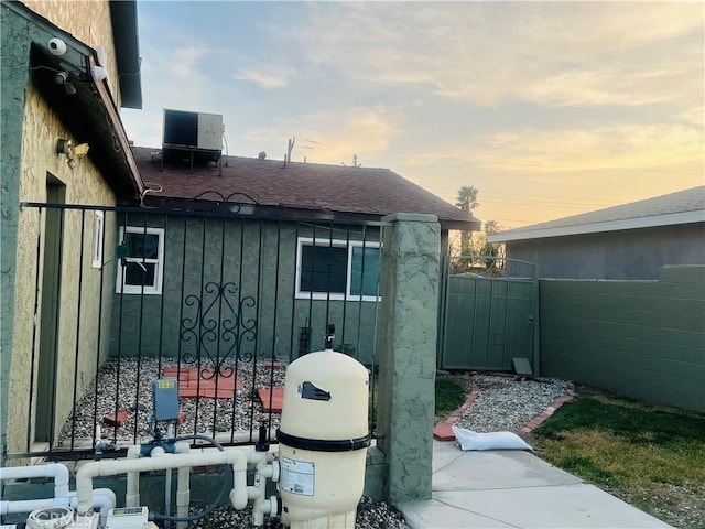 property exterior at dusk featuring central AC unit