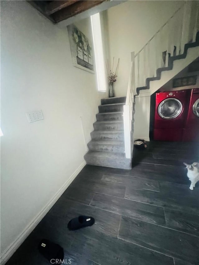 stairway with hardwood / wood-style floors and independent washer and dryer