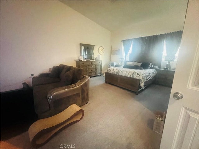 bedroom featuring lofted ceiling and carpet