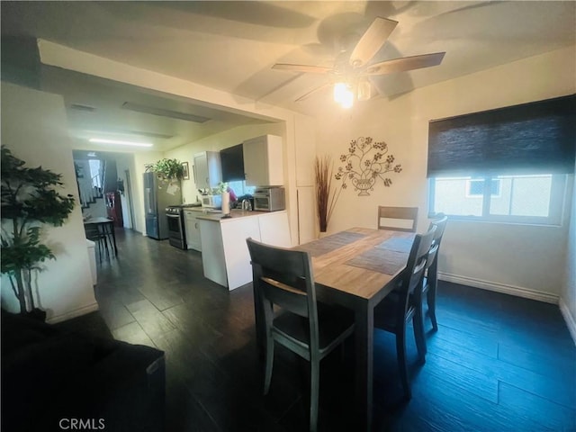 dining room with ceiling fan and dark hardwood / wood-style floors