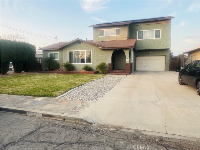 view of front of property with a garage and a front lawn