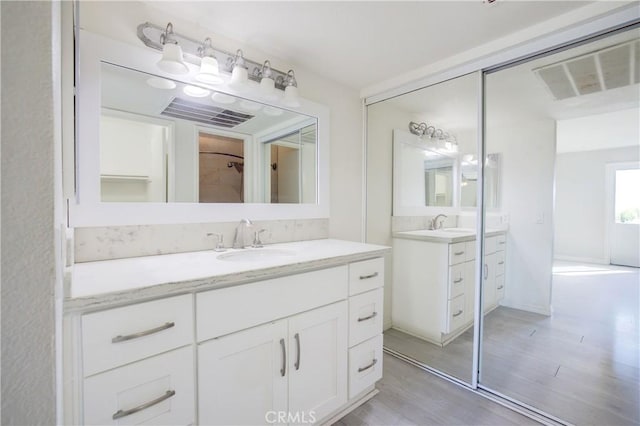 bathroom with vanity and hardwood / wood-style floors